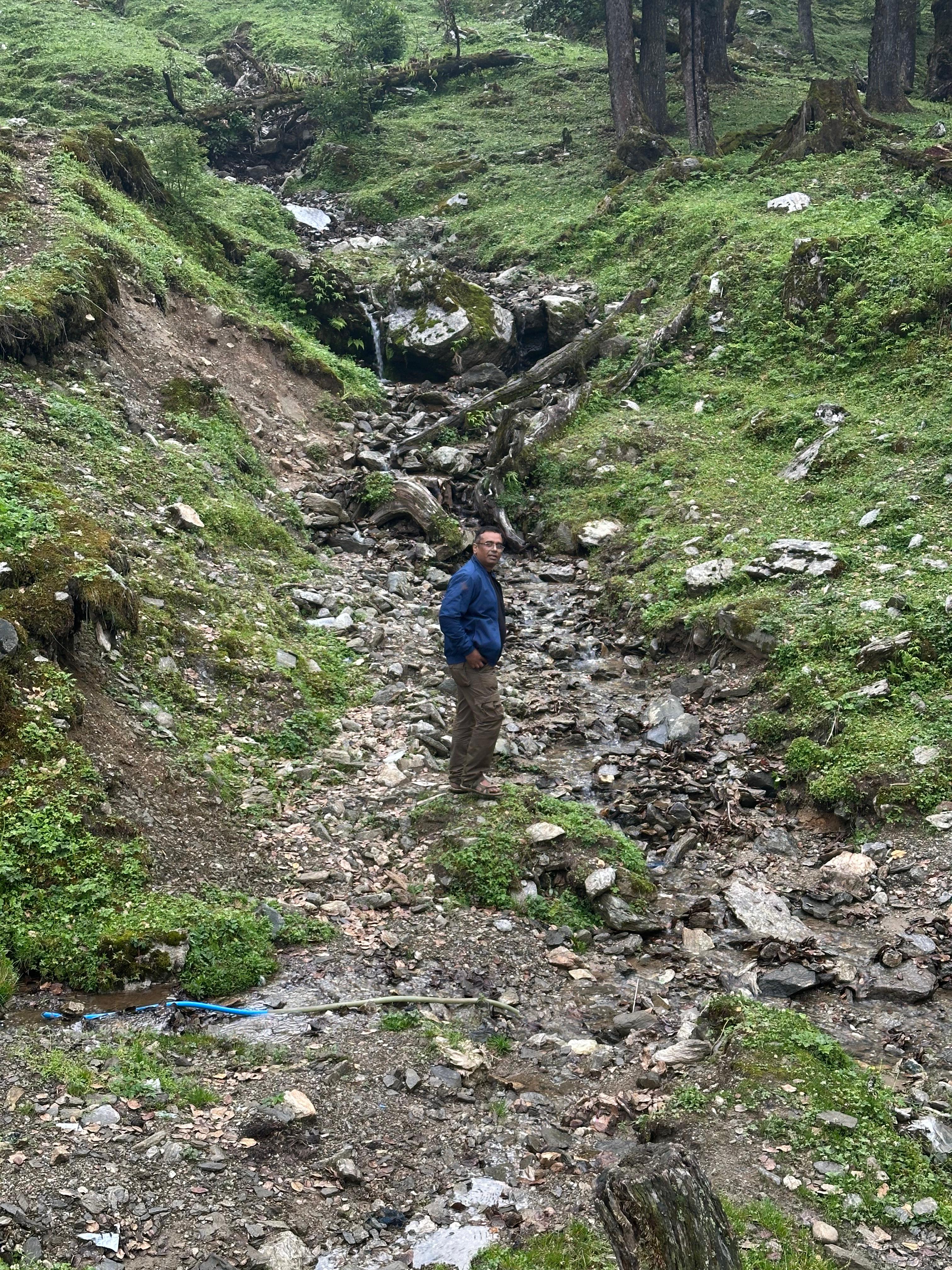 Traveller exploring a forest stream as part of an authentic destination story